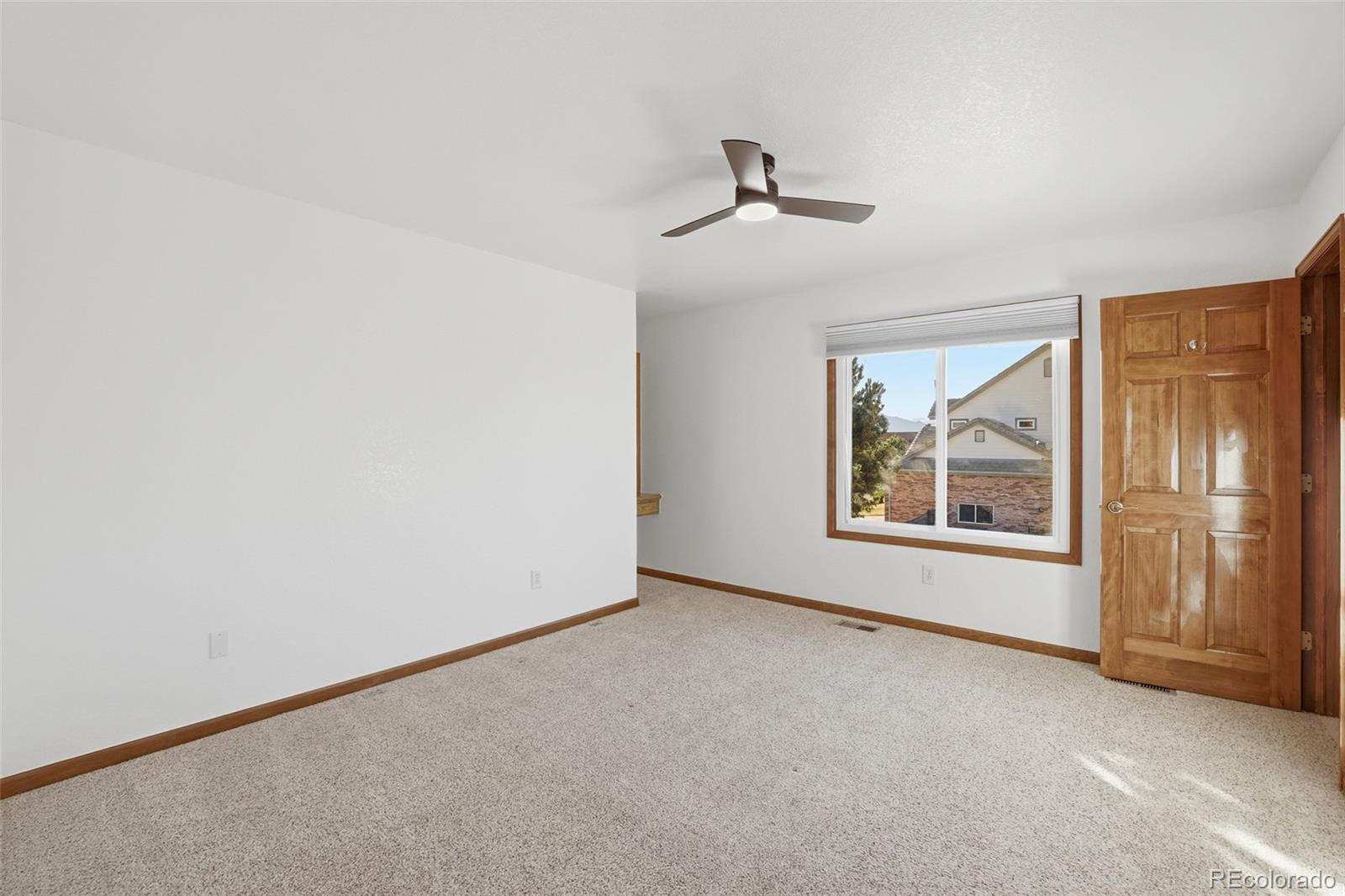 10917 Ammons Street Broomfield, CO 80021 - Photo 28 of 47 an empty room with windows and refrigerator