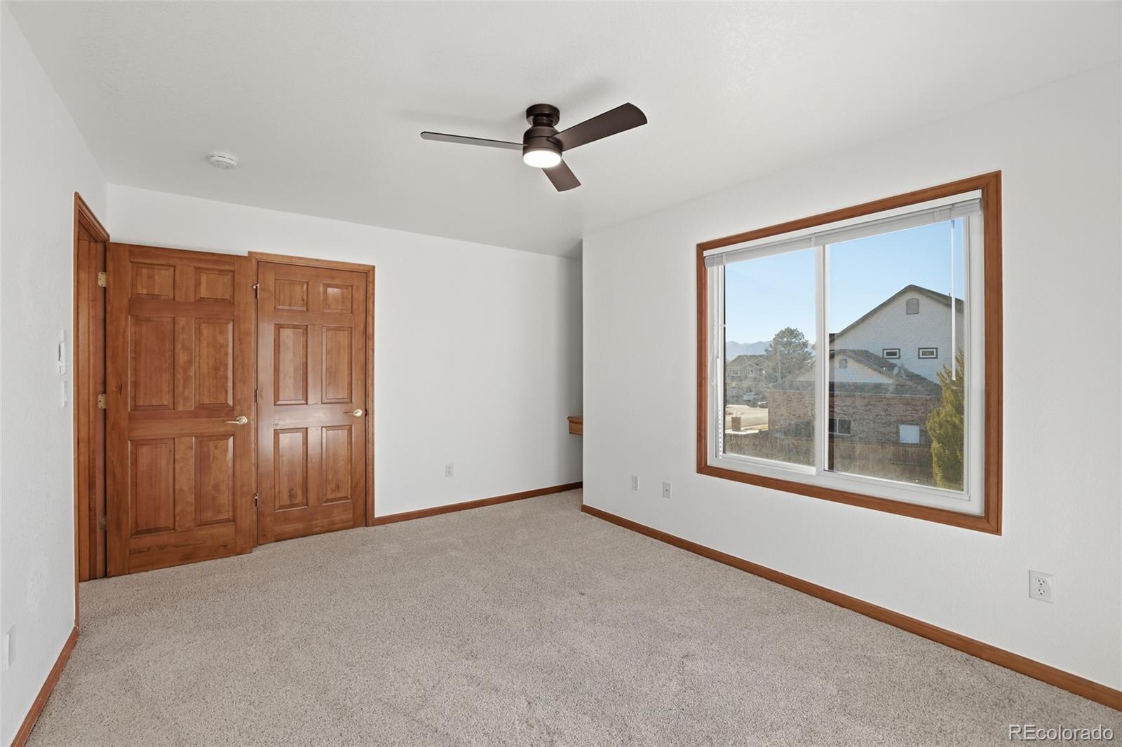 10917 Ammons Street Broomfield, CO 80021 - Photo 31 of 47 an empty room with windows and closet
