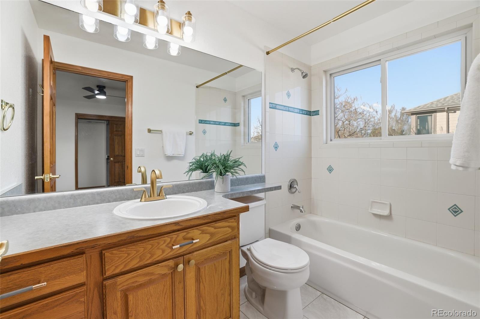 10917 Ammons Street Broomfield, CO 80021 - Photo 34 of 47 a bathroom with a sink a toilet and bathtub