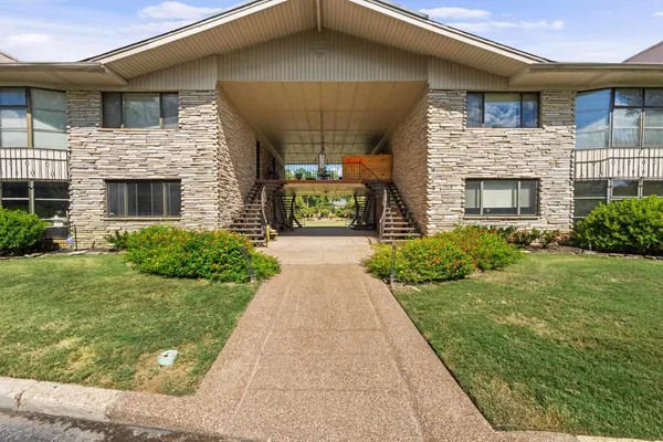 a front view of a house with a garden and plants