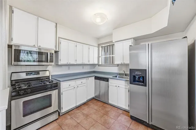 a kitchen with stainless steel appliances granite countertop a stove and a refrigerator