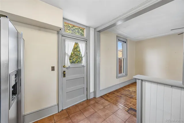 a view of an entryway with wooden floor