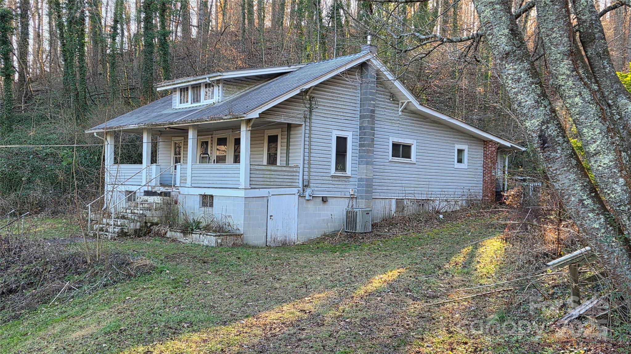 a view of a yard in front of a house with large trees