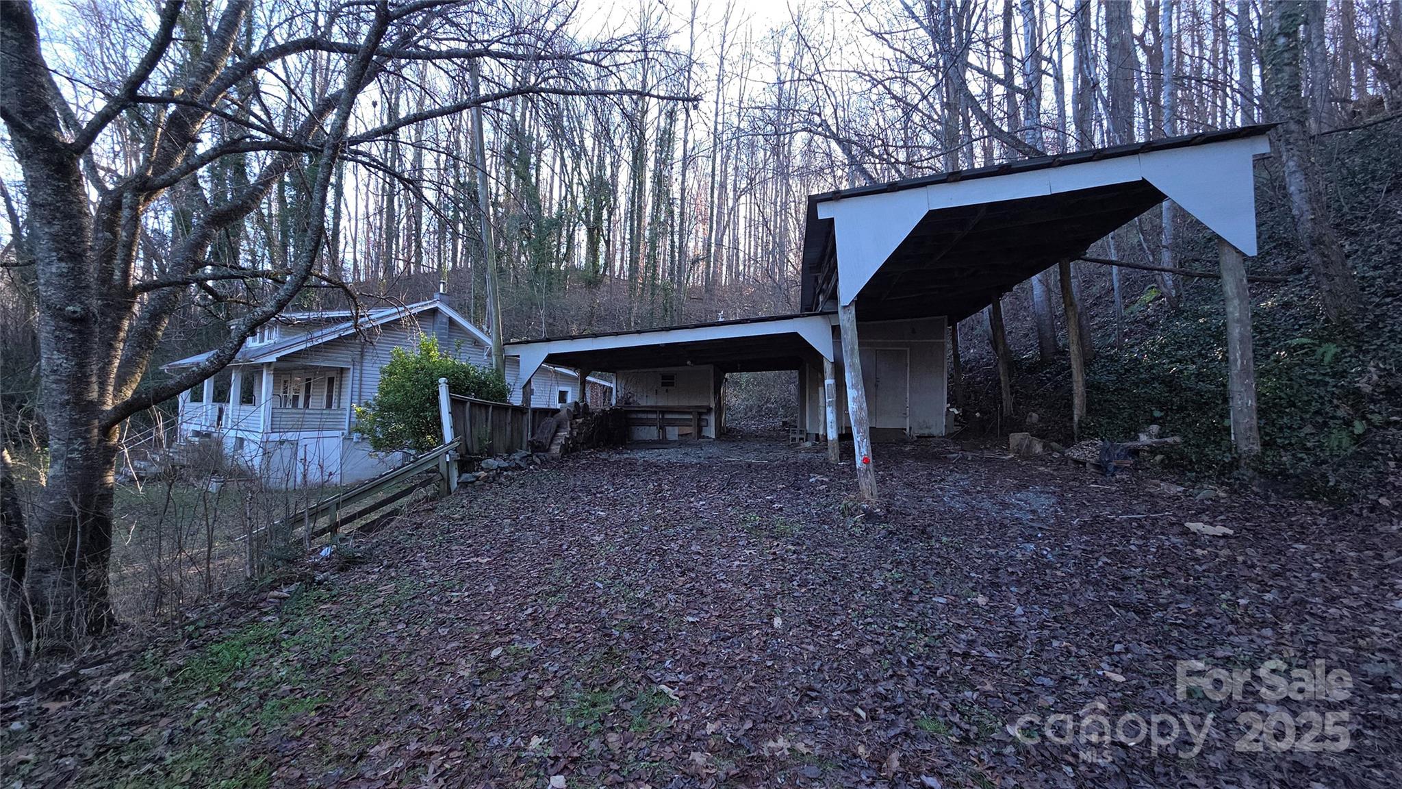 39 Henry Road Sylva, NC 28779 - Photo 18 of 20 a view of backyard with table and chairs under an umbrella