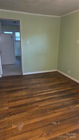 a view of a room with wooden floor