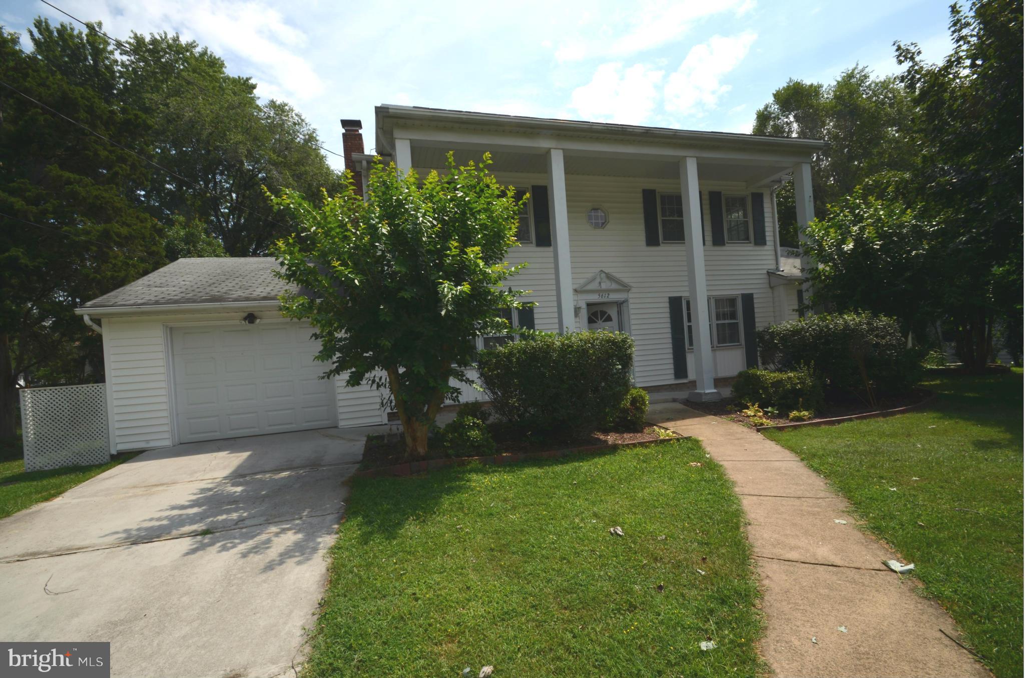5612 Ashfield Road Alexandria, VA 22315 - Photo 2 of 29 a front view of a house with a yard and garage