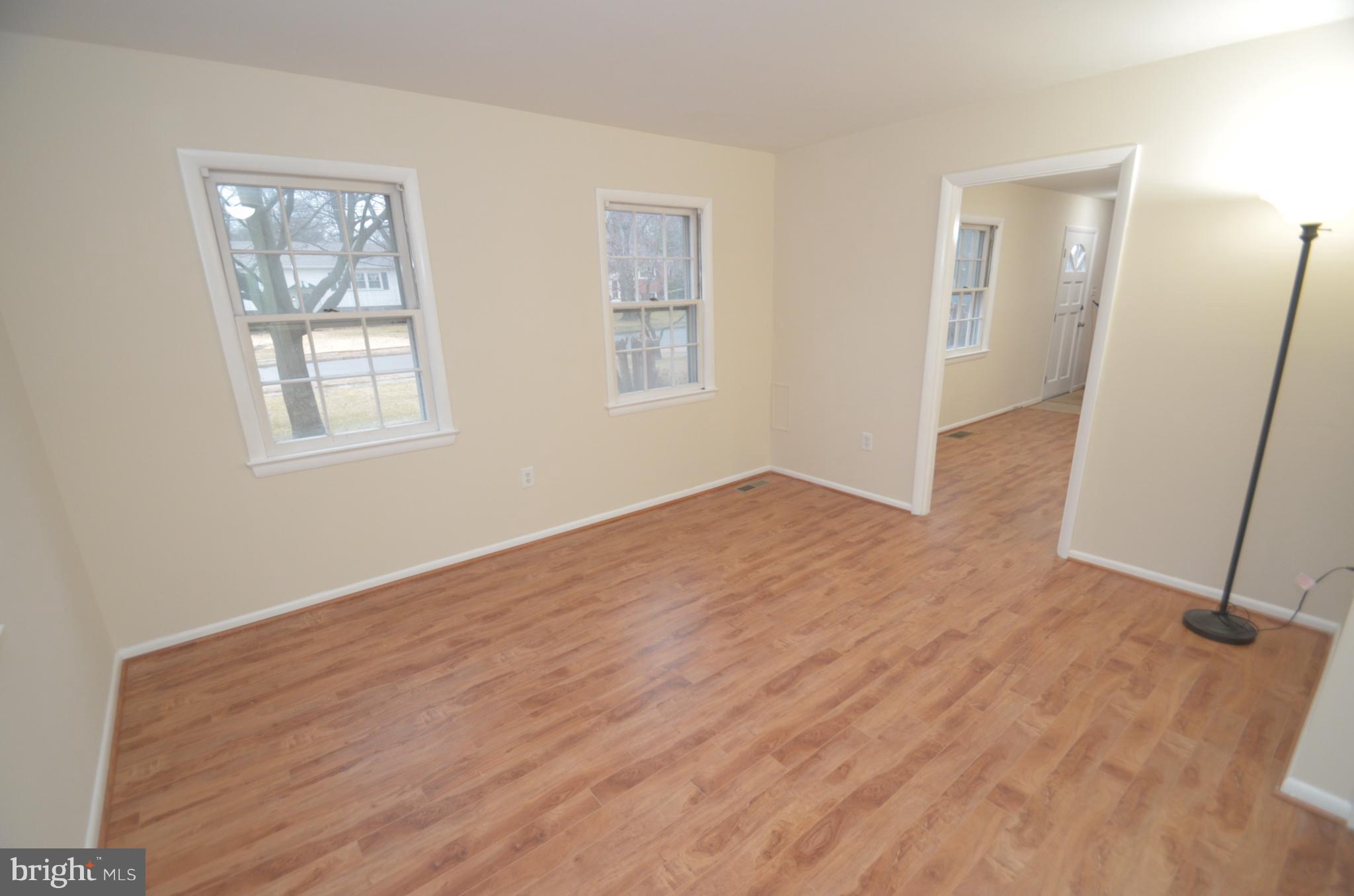 5612 Ashfield Road Alexandria, VA 22315 - Photo 13 of 29 a view of an empty room with wooden floor and a window