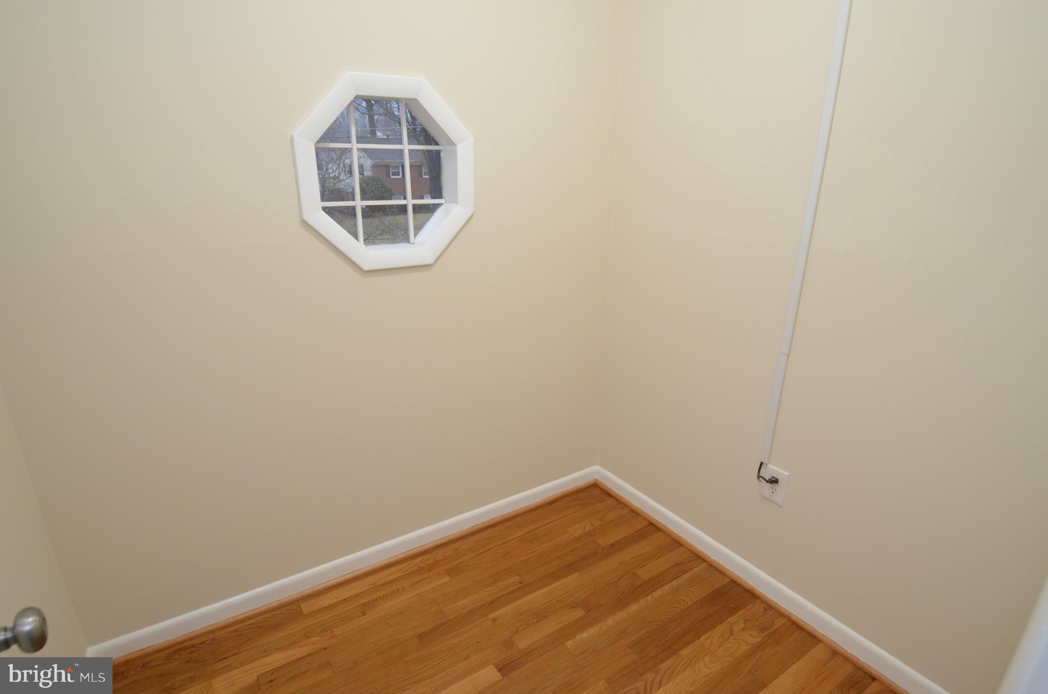 5612 Ashfield Road Alexandria, VA 22315 - Photo 15 of 29 a room with a wooden floor and a window