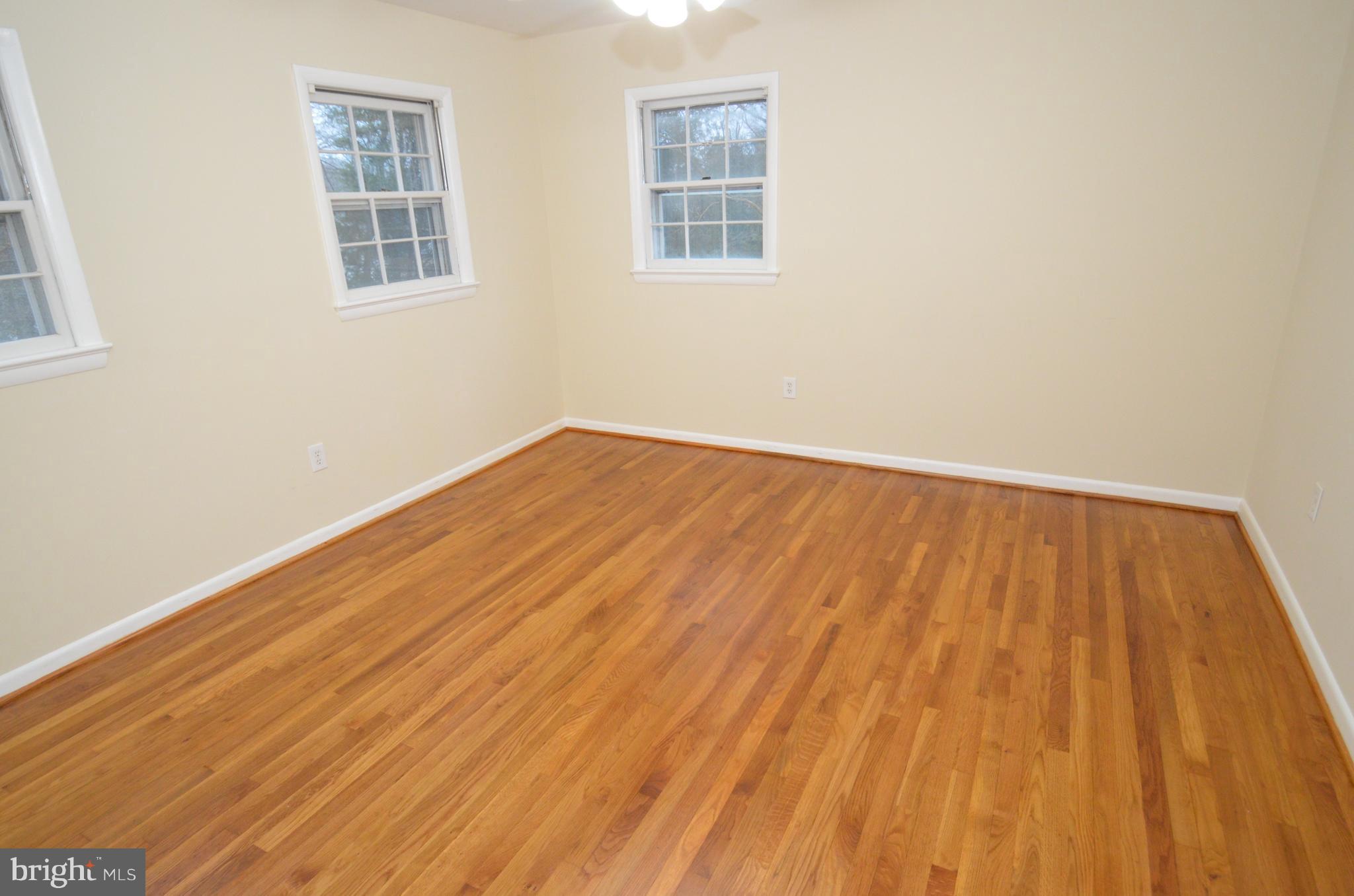 5612 Ashfield Road Alexandria, VA 22315 - Photo 17 of 29 a view of an empty room with wooden floor and a window