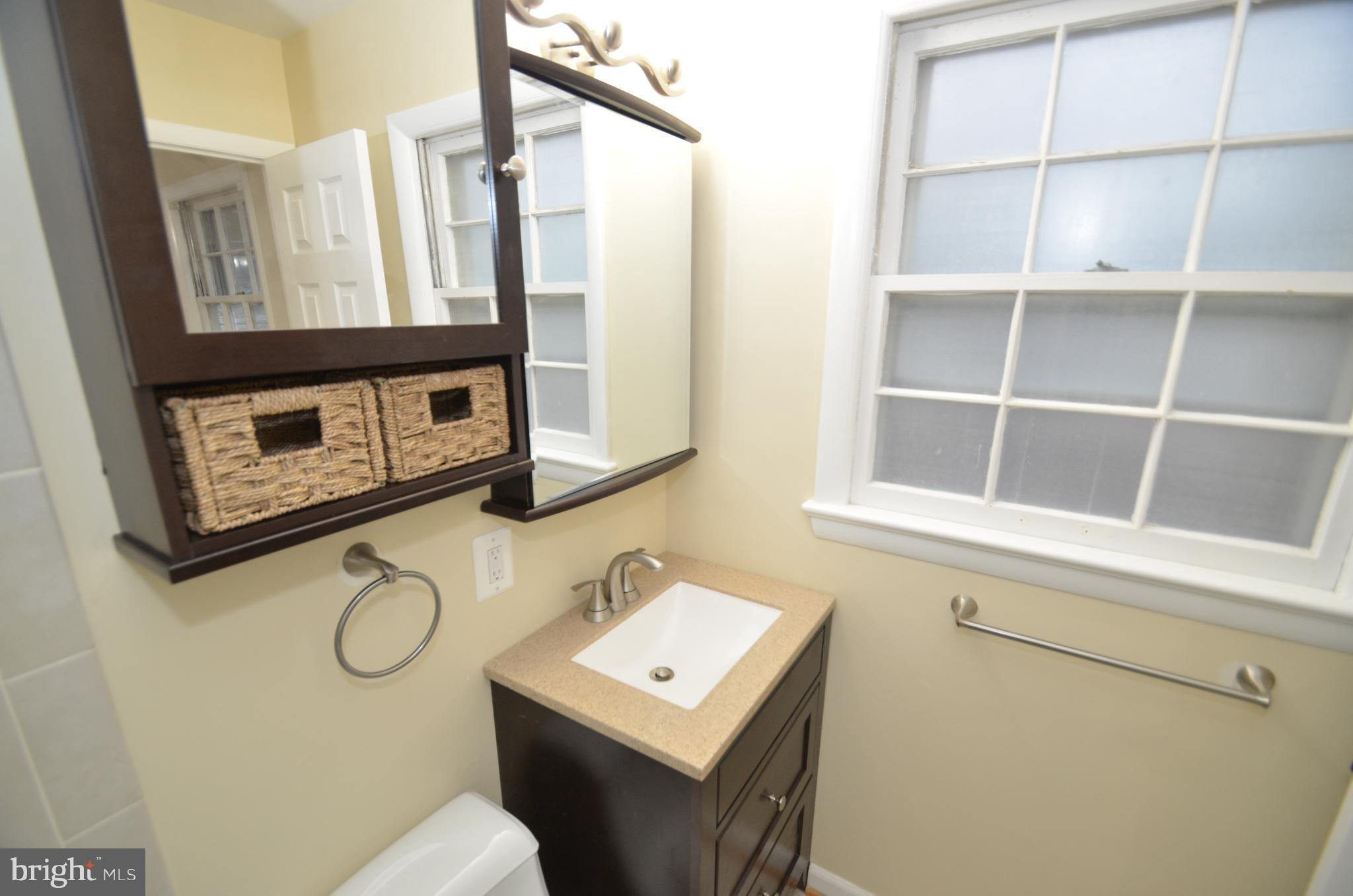 5612 Ashfield Road Alexandria, VA 22315 - Photo 18 of 29 a bathroom with a sink a toilet and a mirror
