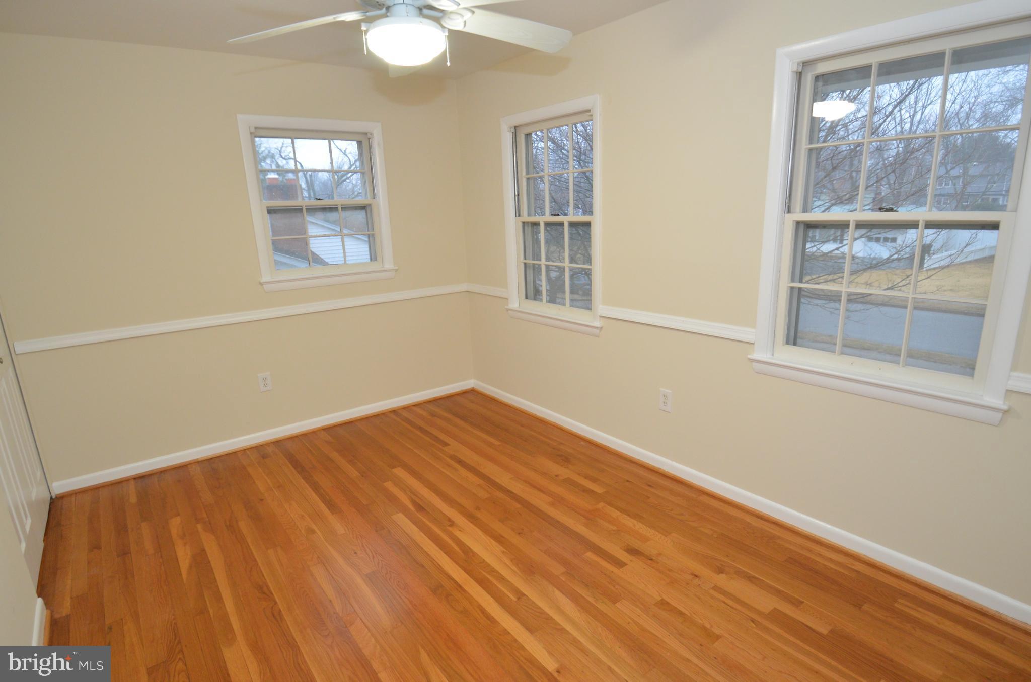 5612 Ashfield Road Alexandria, VA 22315 - Photo 20 of 29 a view of empty room with wooden floor and fan
