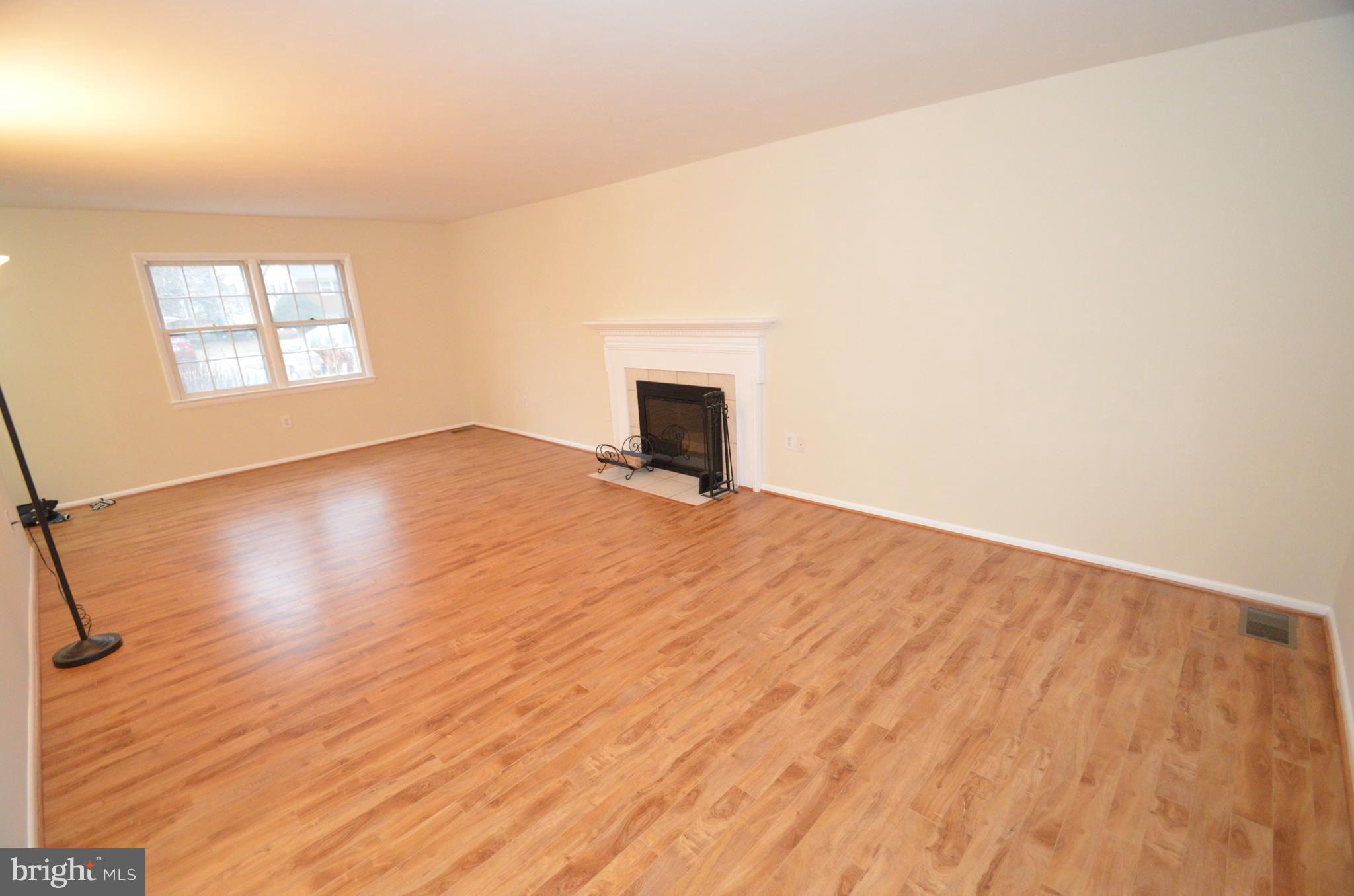 5612 Ashfield Road Alexandria, VA 22315 - Photo 3 of 29 an empty room with wooden floor and windows