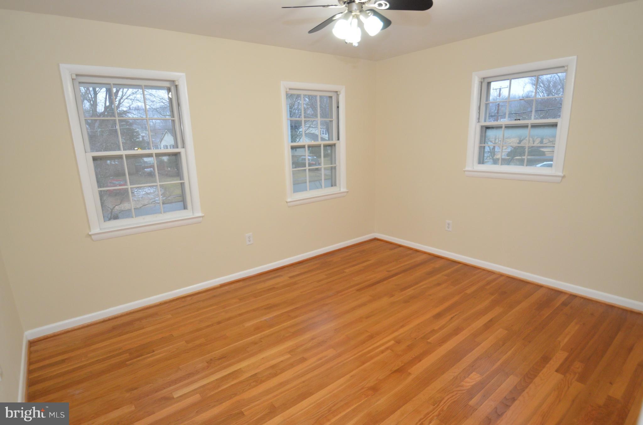 5612 Ashfield Road Alexandria, VA 22315 - Photo 21 of 29 a view of empty room with wooden floor and fan