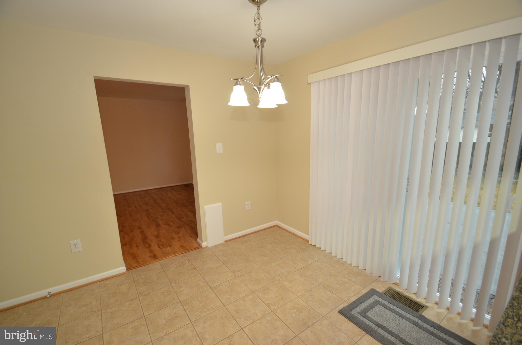 5612 Ashfield Road Alexandria, VA 22315 - Photo 5 of 29 a view of a chandelier fan and entryway