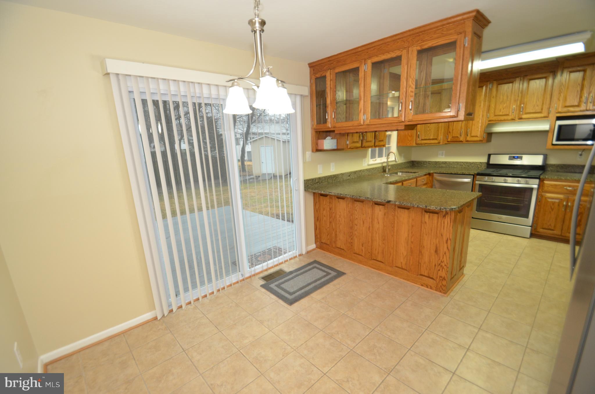 5612 Ashfield Road Alexandria, VA 22315 - Photo 6 of 29 a very nice looking kitchen with granite countertop a stove top oven a sink and dishwasher