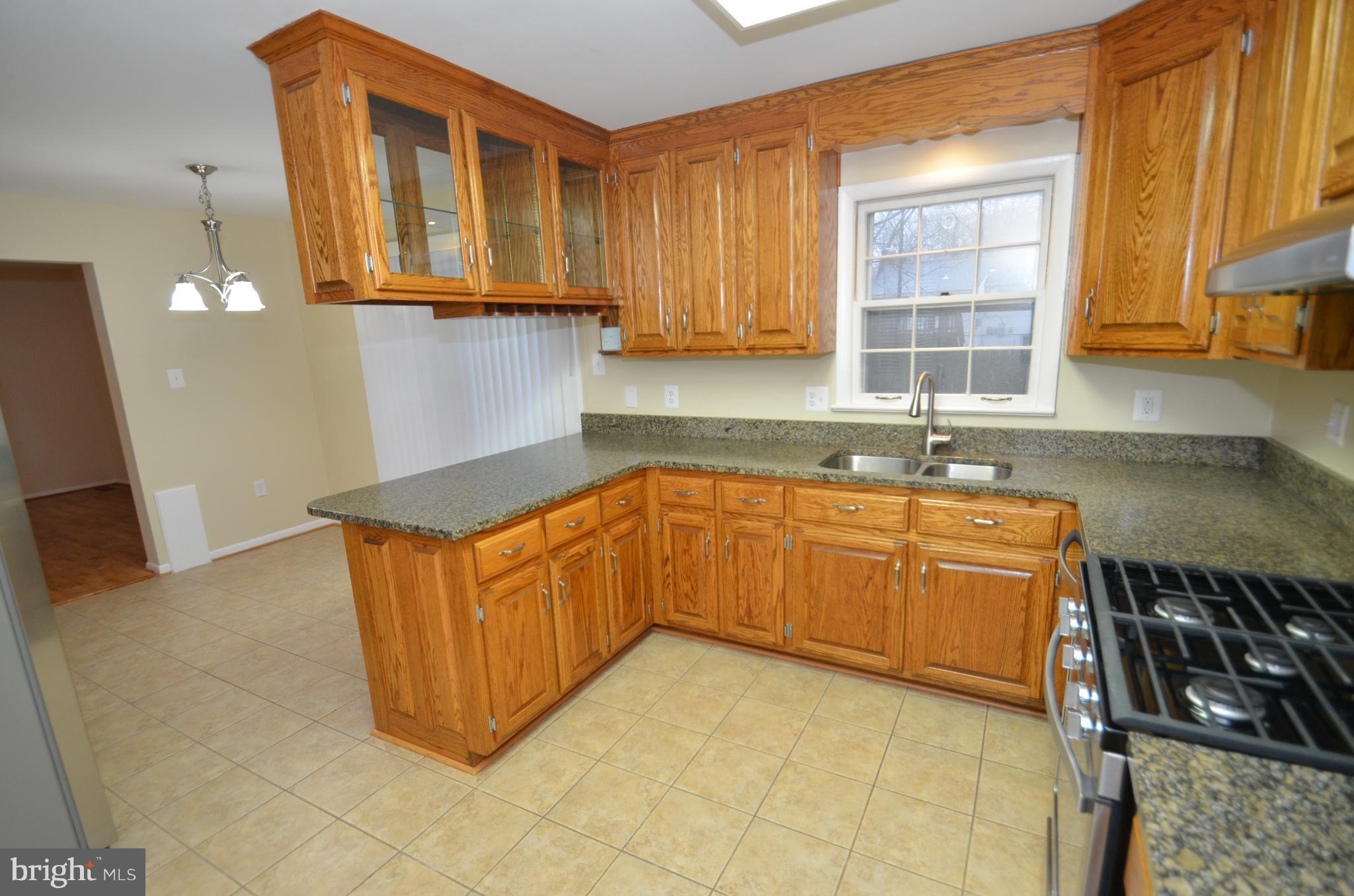 5612 Ashfield Road Alexandria, VA 22315 - Photo 8 of 29 a kitchen with stainless steel appliances granite countertop a sink and a cabinets
