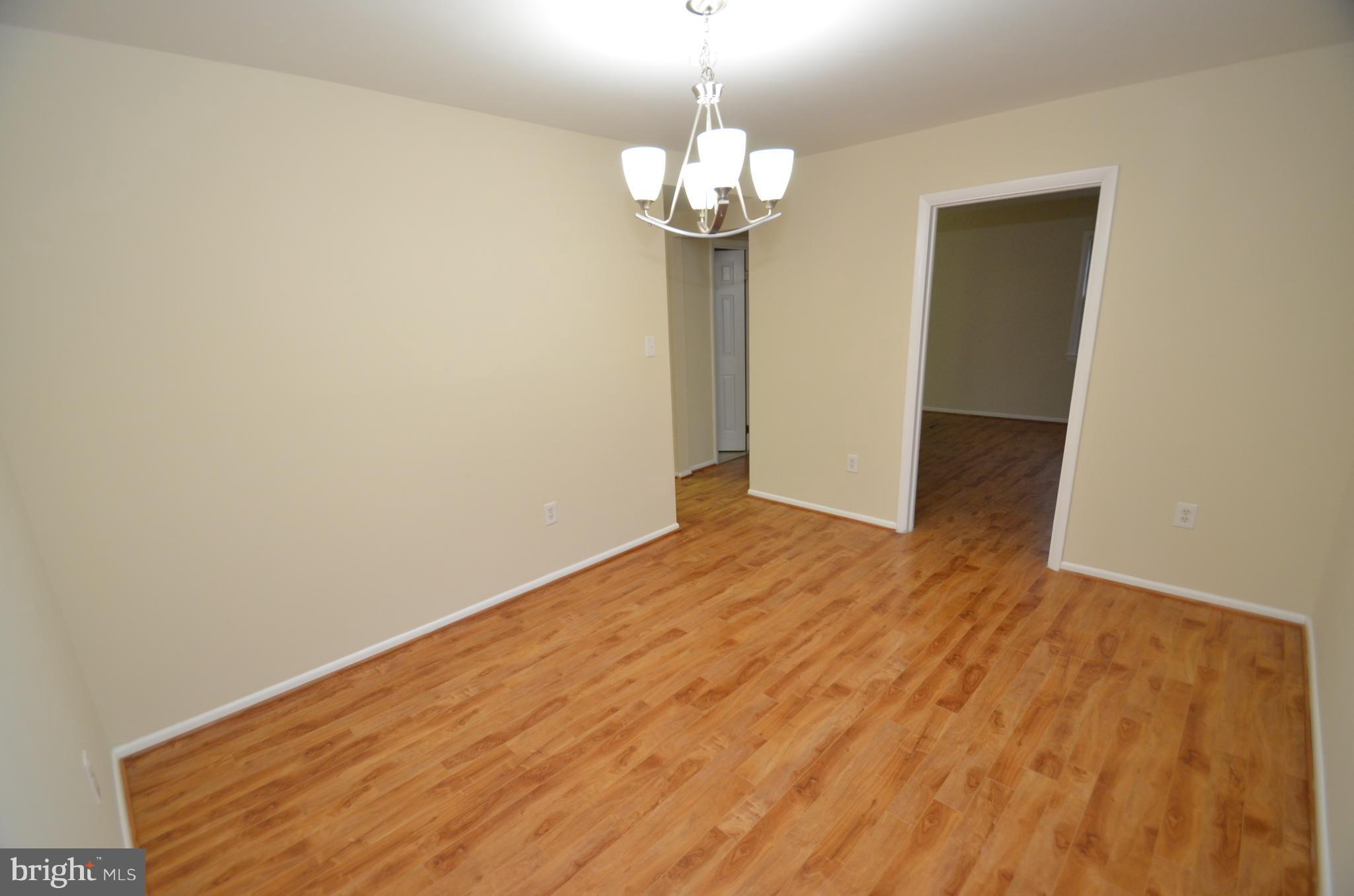 5612 Ashfield Road Alexandria, VA 22315 - Photo 10 of 29 a view of empty room with wooden floor and fan