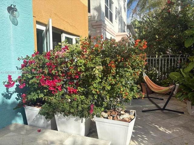 a wooden bench sitting in front of a building