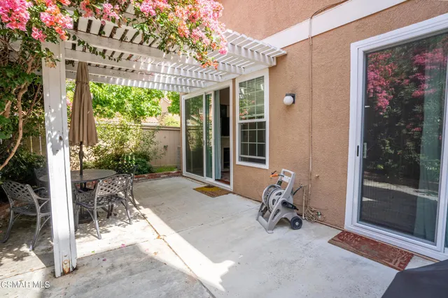 a building outdoor space with patio furniture and potted plants