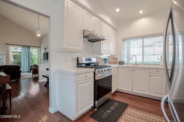 a kitchen with a sink cabinets and appliances