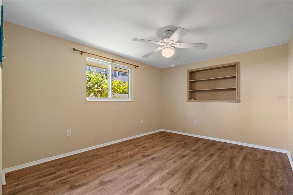 2380 Bay Street Sarasota, FL 34237 - Photo 17 of 48 a view of an empty room with wooden floor and a window