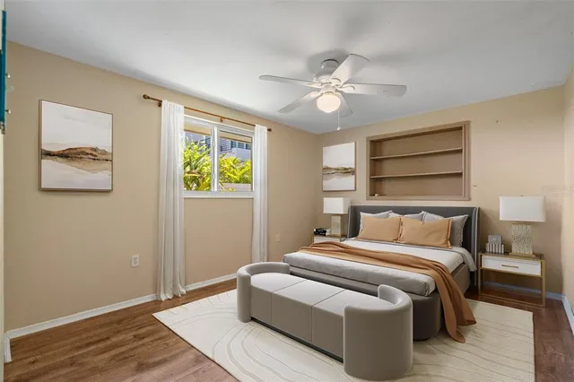 a bedroom with a bed and wooden floor
