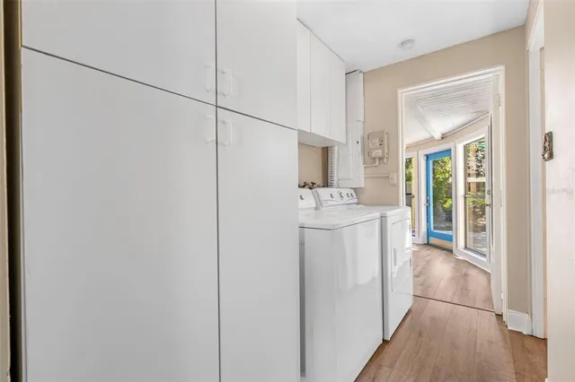 a utility room with cabinets washer and dryer