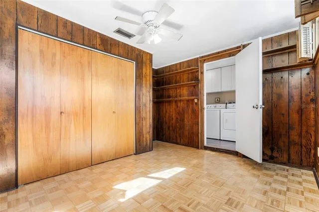 a view of a big room with closet and chandelier fan
