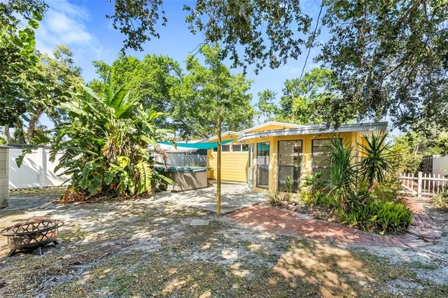 a view of a house with a tree in the yard