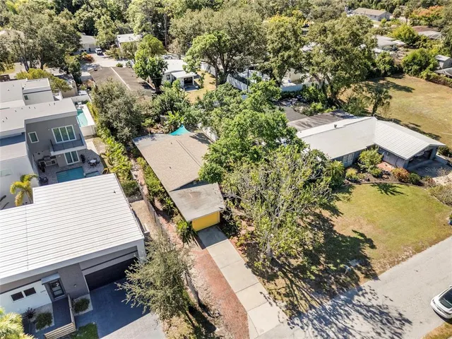 an aerial view of a house with a yard