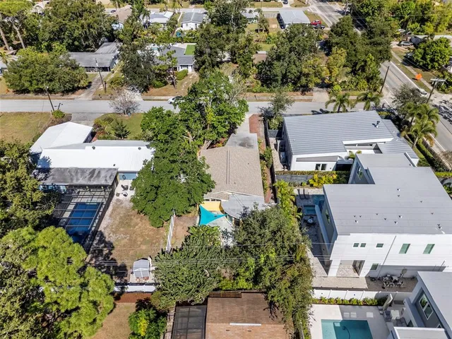 an aerial view of residential houses with outdoor space