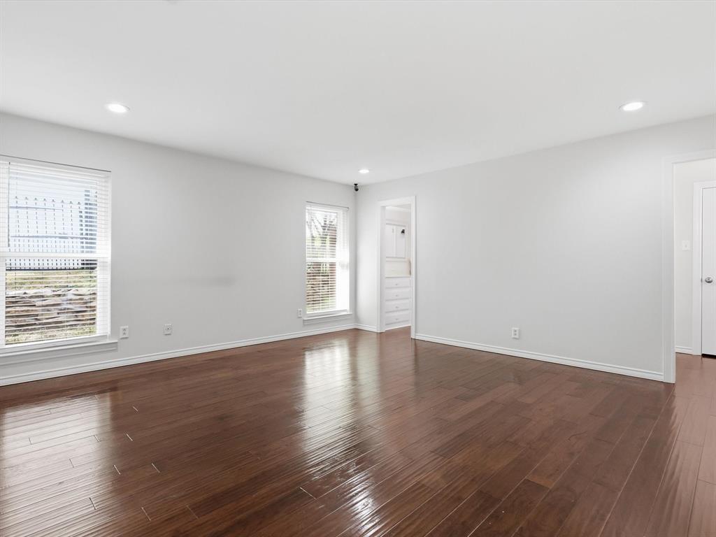 4300 Winding Way Benbrook, TX 76126 - Photo 14 of 24 an empty room with wooden floor and windows