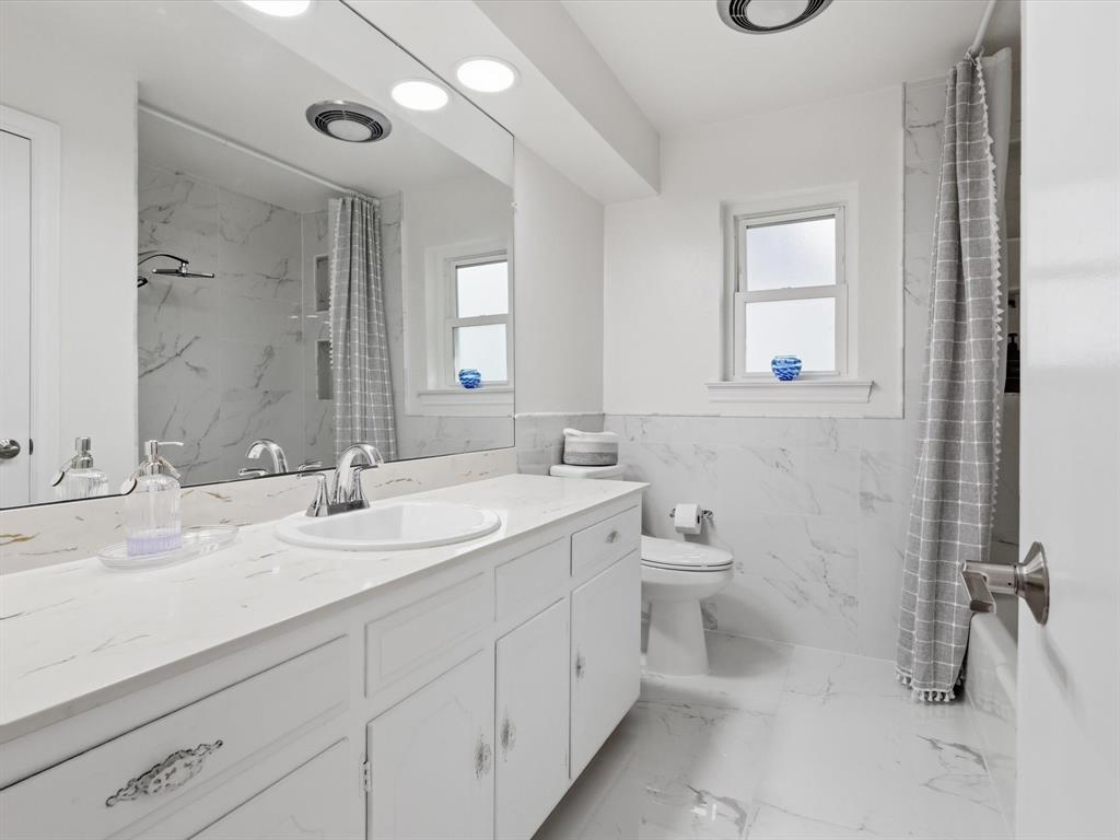 4300 Winding Way Benbrook, TX 76126 - Photo 19 of 24 a bathroom with a double vanity sink and a mirror