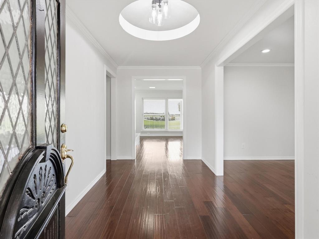 4300 Winding Way Benbrook, TX 76126 - Photo 4 of 24 a view of a hallway with wooden floor and a bathroom