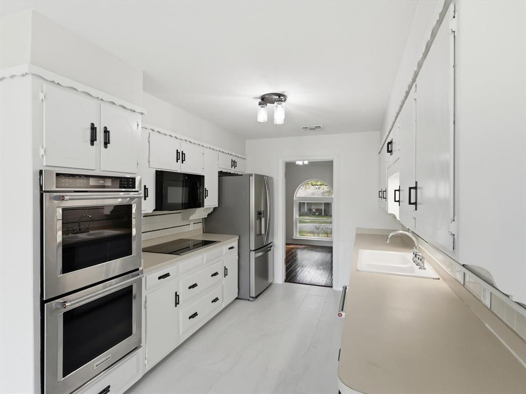 4300 Winding Way Benbrook, TX 76126 - Photo 5 of 24 a kitchen with stainless steel appliances white cabinets and a stove