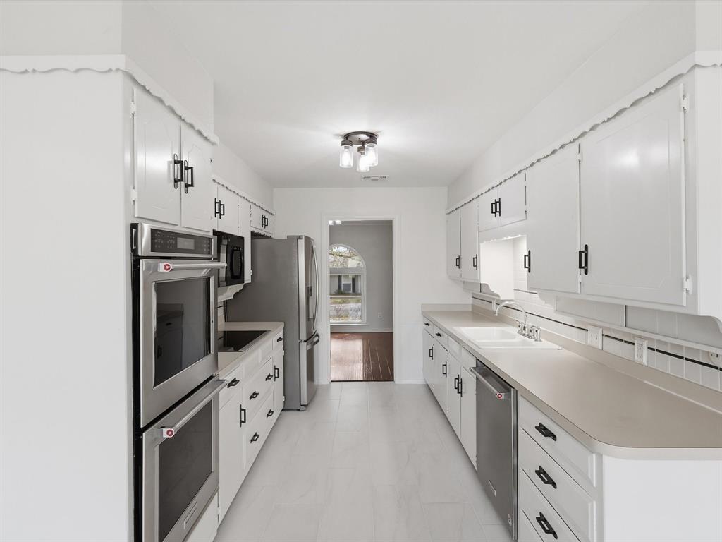 4300 Winding Way Benbrook, TX 76126 - Photo 7 of 24 a large kitchen with cabinets a sink and stainless steel appliances
