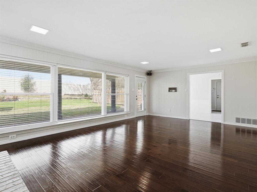 4300 Winding Way Benbrook, TX 76126 - Photo 9 of 24 a view of an empty room with wooden floor and a window