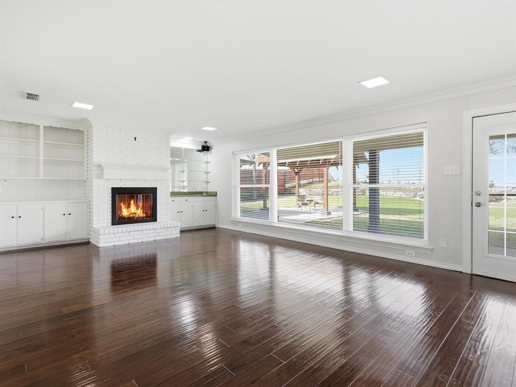 4300 Winding Way Benbrook, TX 76126 - Photo 10 of 24 an empty room with wooden floor and windows
