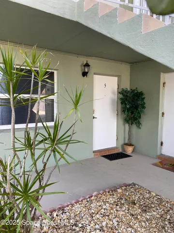 a picture of a building with potted plants