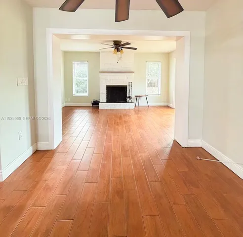 wooden floor fireplace and windows in a room