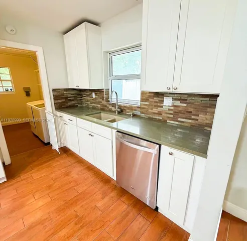 a kitchen with stainless steel appliances granite countertop a sink stove and cabinets