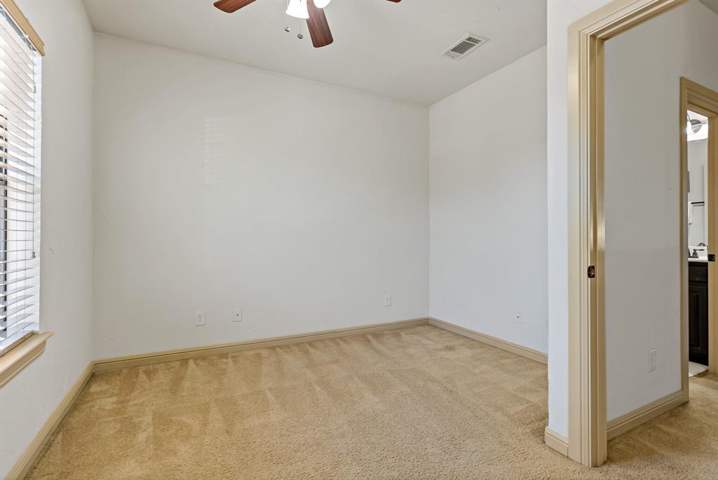11118 Marion Road, Unit 105 Sanger, TX 76266 - Photo 25 of 29 Carpeted interior space featuring a window with horizontal blinds, a ceiling fan with integrated lighting, and a recessed ceiling vent