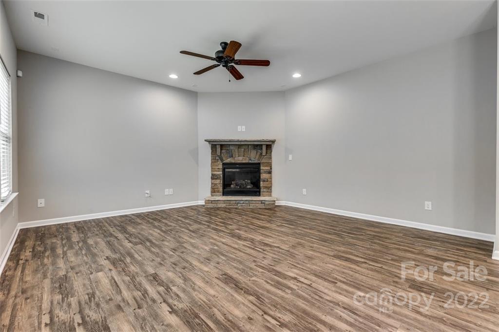 6403 Bluegill Road Charlotte, NC 28216 - Photo 11 of 48 a view of an empty room with a fireplace and a window