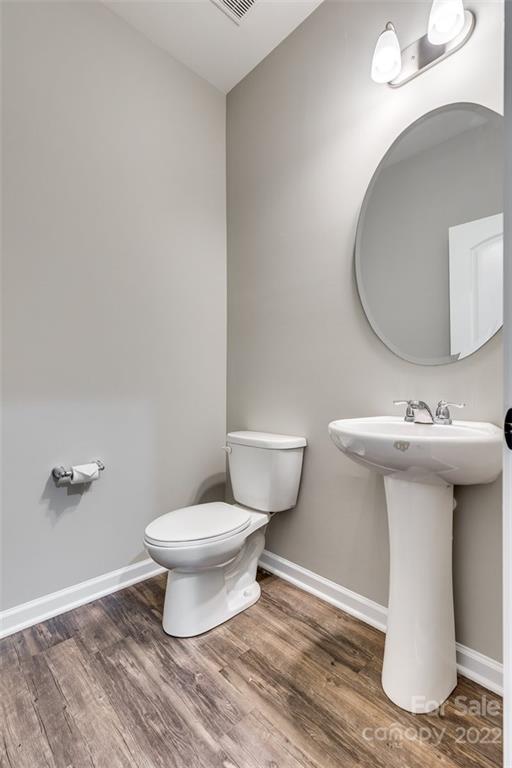 6403 Bluegill Road Charlotte, NC 28216 - Photo 17 of 48 a bathroom with a sink toilet and a mirror