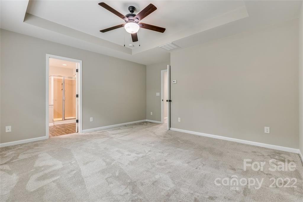 6403 Bluegill Road Charlotte, NC 28216 - Photo 24 of 48 an empty room with a ceiling fan and a window