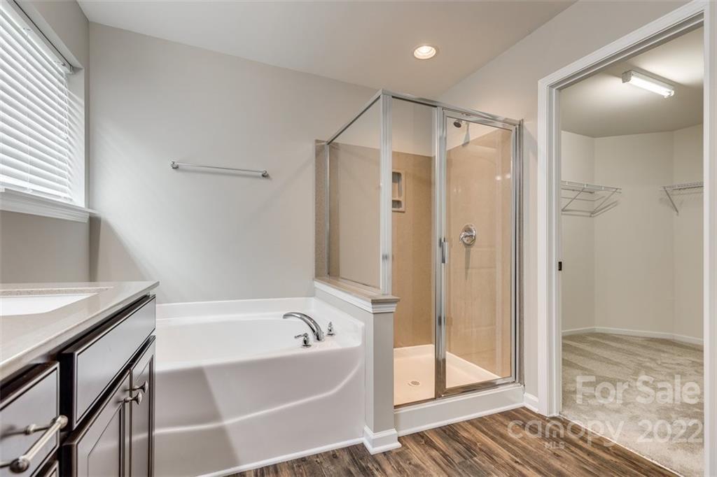 6403 Bluegill Road Charlotte, NC 28216 - Photo 26 of 48 a bathroom with a bathtub and a shower