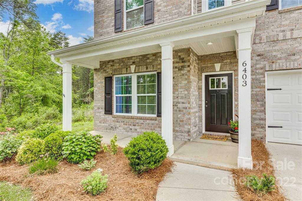 6403 Bluegill Road Charlotte, NC 28216 - Photo 3 of 48 front view of a brick house with a large window