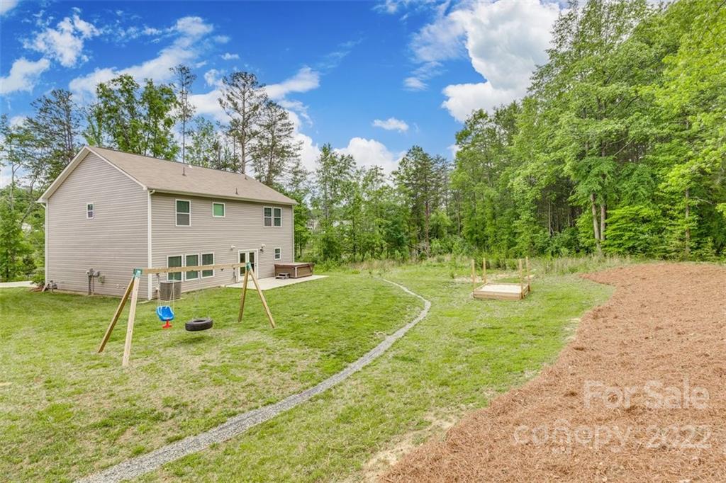 6403 Bluegill Road Charlotte, NC 28216 - Photo 39 of 48 a view of a house with a backyard and a tree