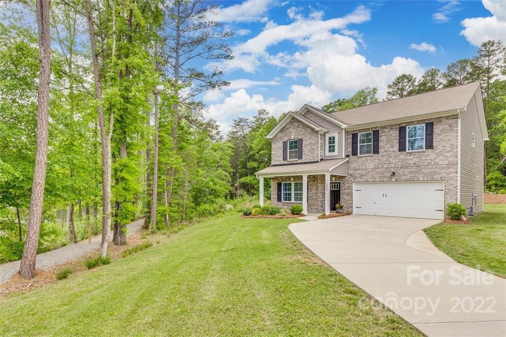 6403 Bluegill Road Charlotte, NC 28216 - Photo 42 of 48 a view of house with a big yard and large trees