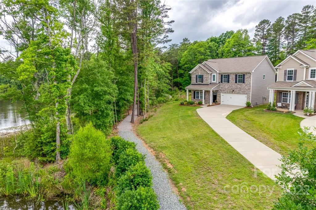 6403 Bluegill Road Charlotte, NC 28216 - Photo 43 of 48 a front view of a house with a yard table and chairs